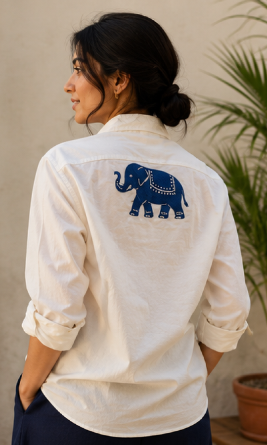 Woman wearing a white shirt, organic cotton shirt, with a blue elephant handblock on the back