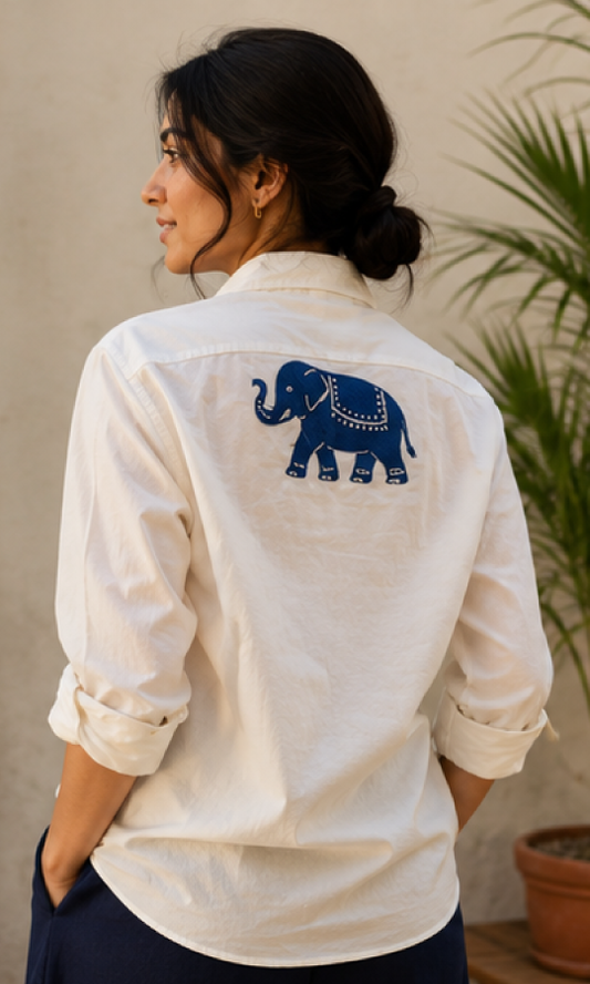 Woman wearing a white shirt, organic cotton shirt, with a blue elephant handblock on the back
